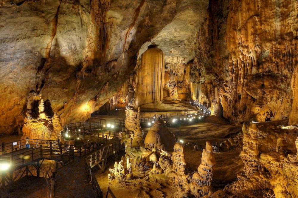 Majestic stalactites and stalagmites rise from the cave floor like natural sculptures